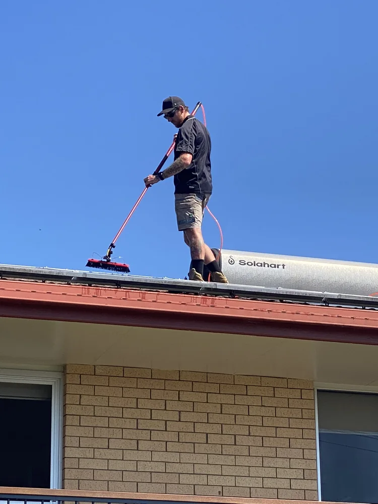 Brodie Ellwood owner of Be Clean Exteriors working on a roof cleaning job